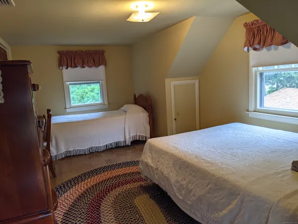 a bedroom with a bed and window