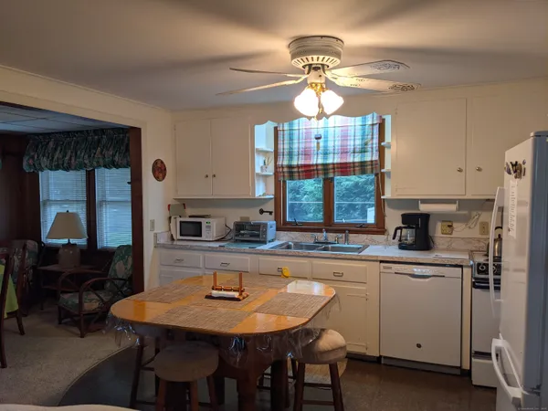 a kitchen with a dining table and chairs
