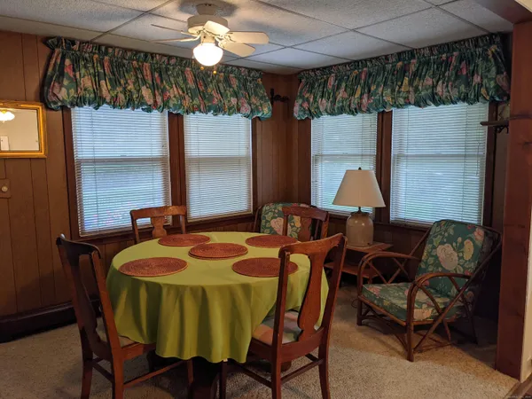 a view of a dining room with furniture and chandelier