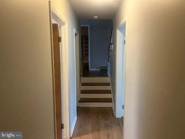 a view of a hallway with wooden shelves