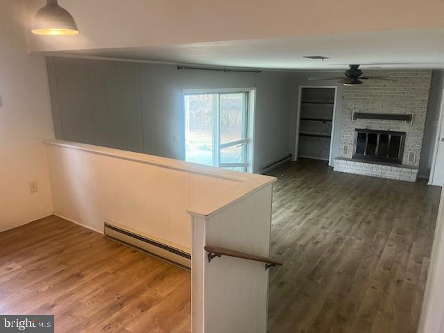 10038 Pleasant View Drive Hagerstown, MD 21740 - Photo 27 of 28 an empty room with wooden floor fireplace and windows