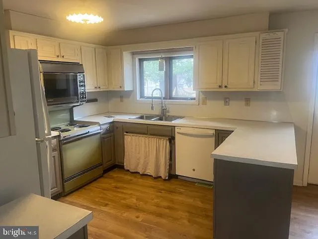 a kitchen with a sink stove and refrigerator