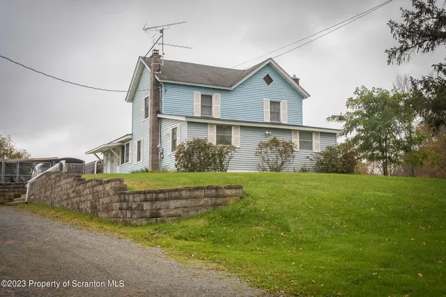 a view of a house with a yard and plants
