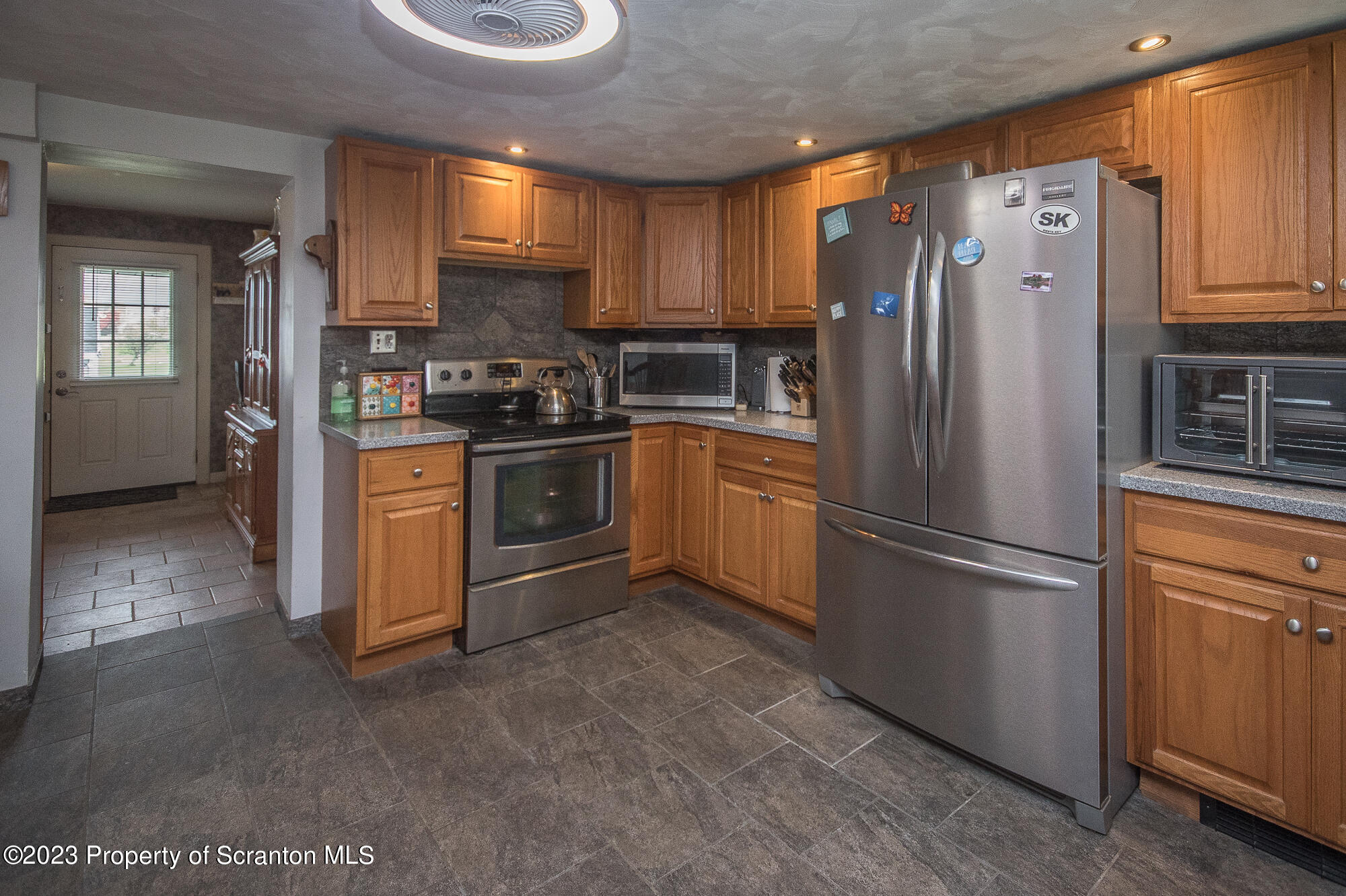 776 Milanville Road Beach Lake, PA 18405 - Photo 18 of 28 a kitchen with stainless steel appliances granite countertop a refrigerator sink and cabinets