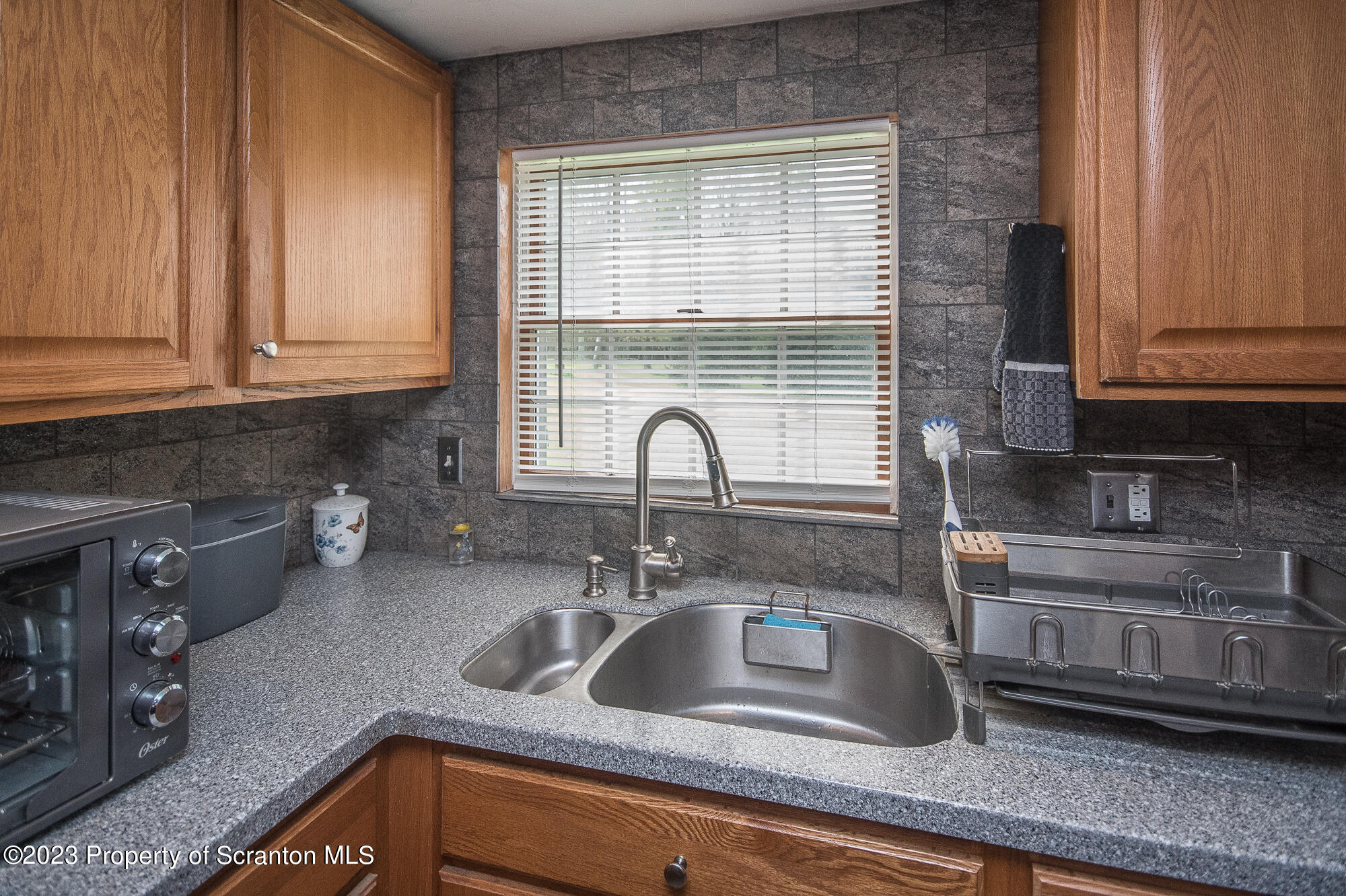 776 Milanville Road Beach Lake, PA 18405 - Photo 19 of 28 a kitchen with granite countertop a sink and a window
