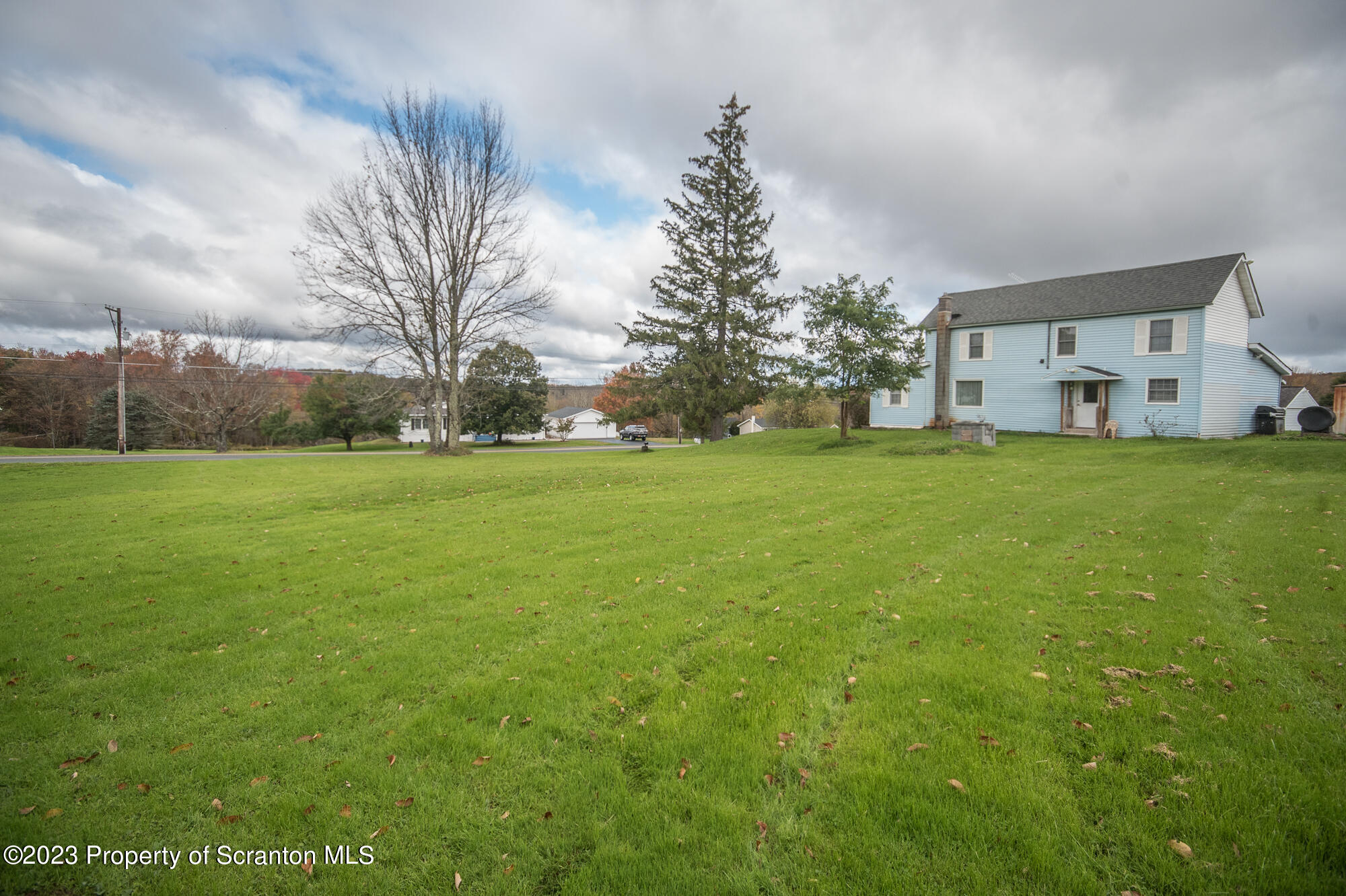 776 Milanville Road Beach Lake, PA 18405 - Photo 25 of 28 a view of a house with a big yard and large trees