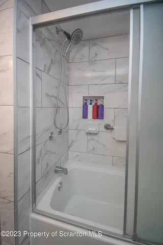 a bathroom with a bathtub and shower