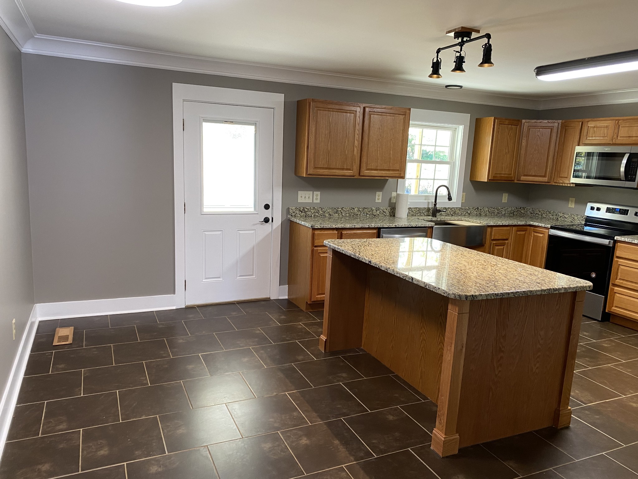1513 Normandy Road Normandy, TN 37360 - Photo 10 of 29 a kitchen with kitchen island granite countertop a sink a counter top space and cabinets