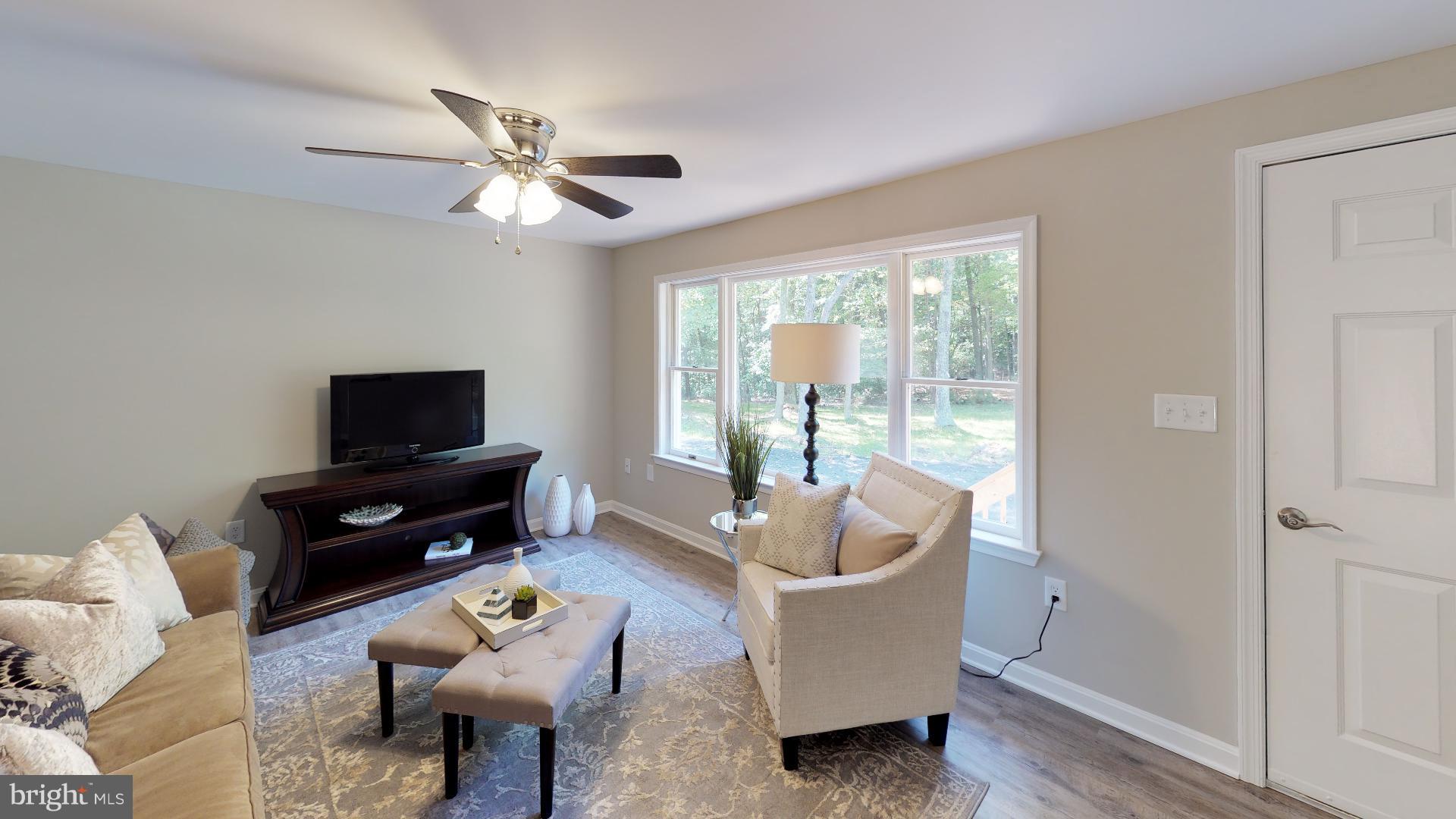 13284 Joy Road Lusby, MD 20657 - Photo 11 of 29 a living room with furniture a flat screen tv and a window