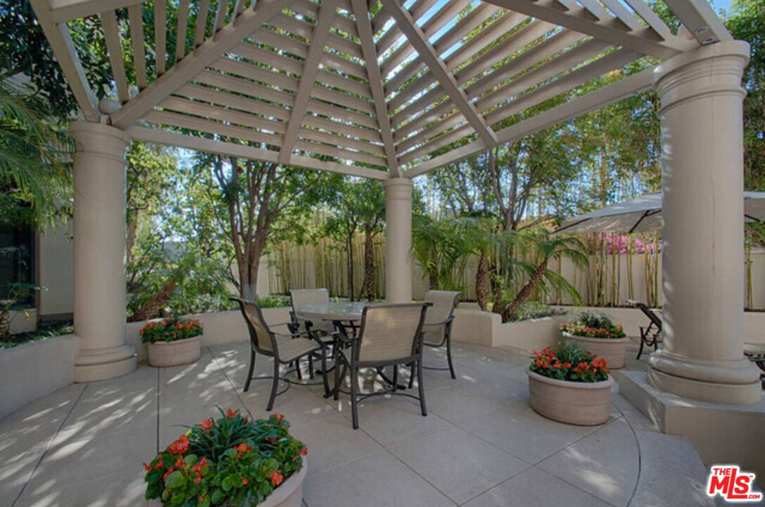10724 Wilshire Boulevard, Unit 1001 Los Angeles, CA 90024 - Photo 15 of 20 a outdoor dining space with furniture and potted plants