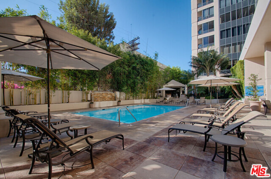 10724 Wilshire Boulevard, Unit 1001 Los Angeles, CA 90024 - Photo 16 of 20 a view of a swimming pool with lounge chairs