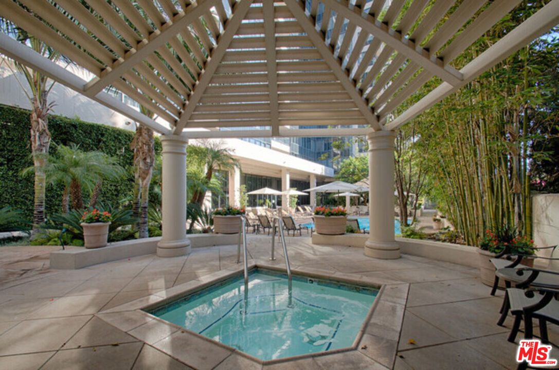 10724 Wilshire Boulevard, Unit 1001 Los Angeles, CA 90024 - Photo 17 of 20 a view of a swimming pool with a patio