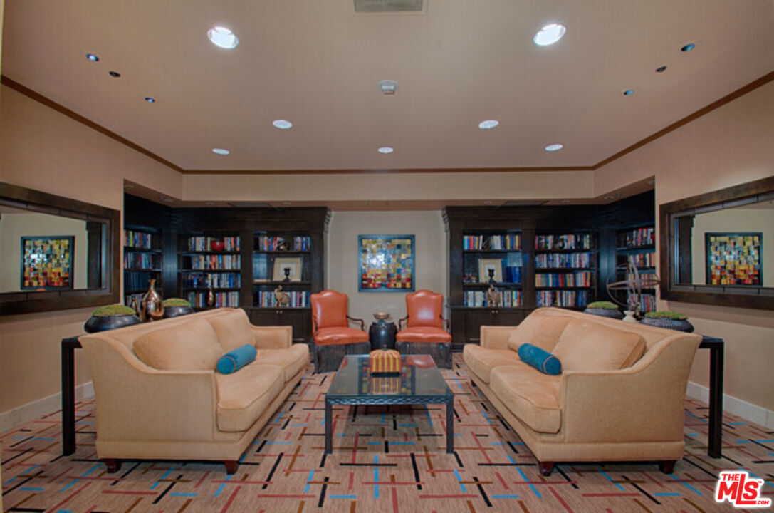 10724 Wilshire Boulevard, Unit 1001 Los Angeles, CA 90024 - Photo 5 of 20 a living room with furniture and a book shelf