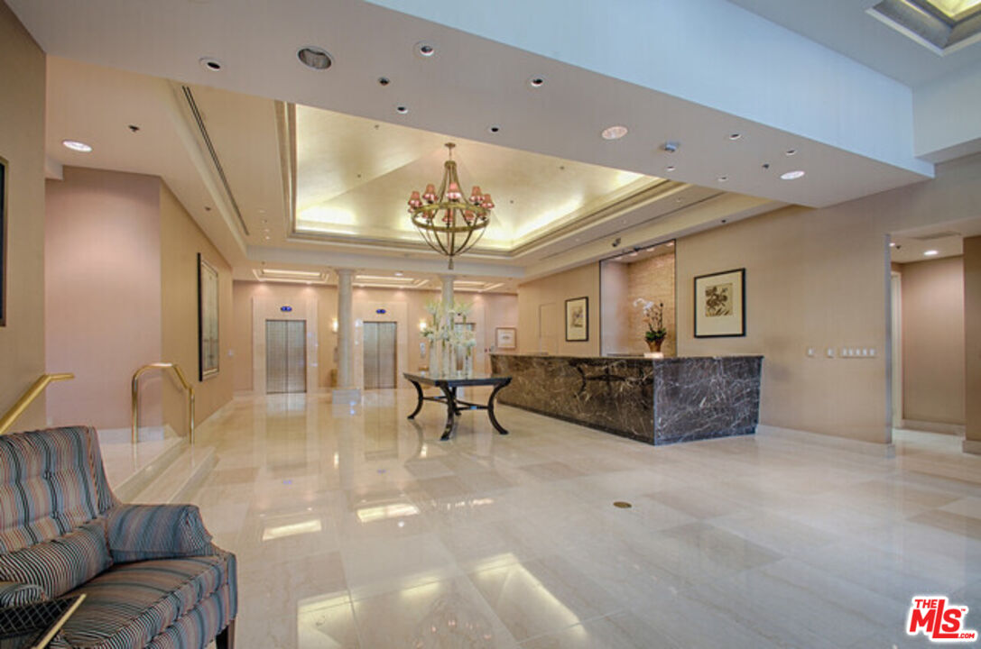 10724 Wilshire Boulevard, Unit 1001 Los Angeles, CA 90024 - Photo 6 of 20 a living room with furniture and a chandelier