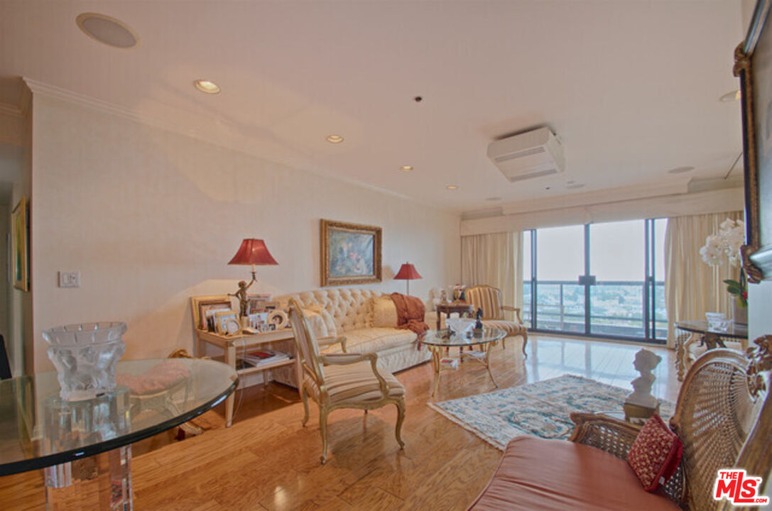 10724 Wilshire Boulevard, Unit 1001 Los Angeles, CA 90024 - Photo 8 of 20 a living room with furniture and a table