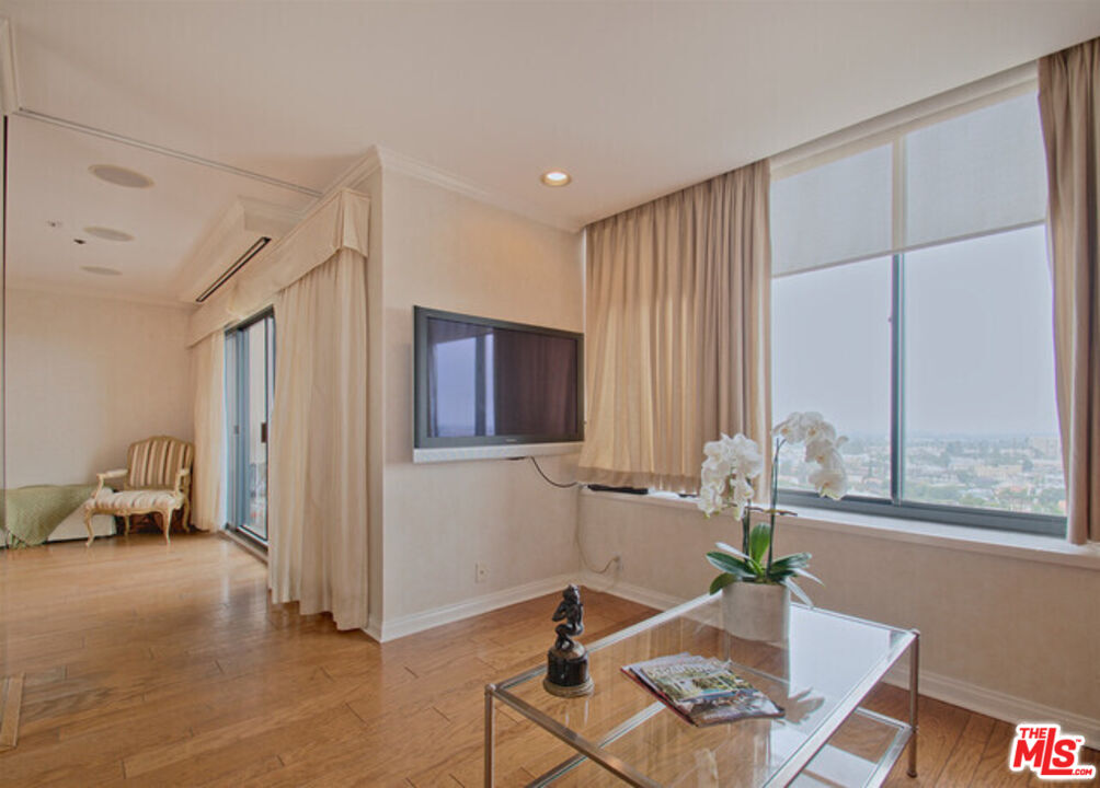 10724 Wilshire Boulevard, Unit 1001 Los Angeles, CA 90024 - Photo 9 of 20 a living room with furniture and a window
