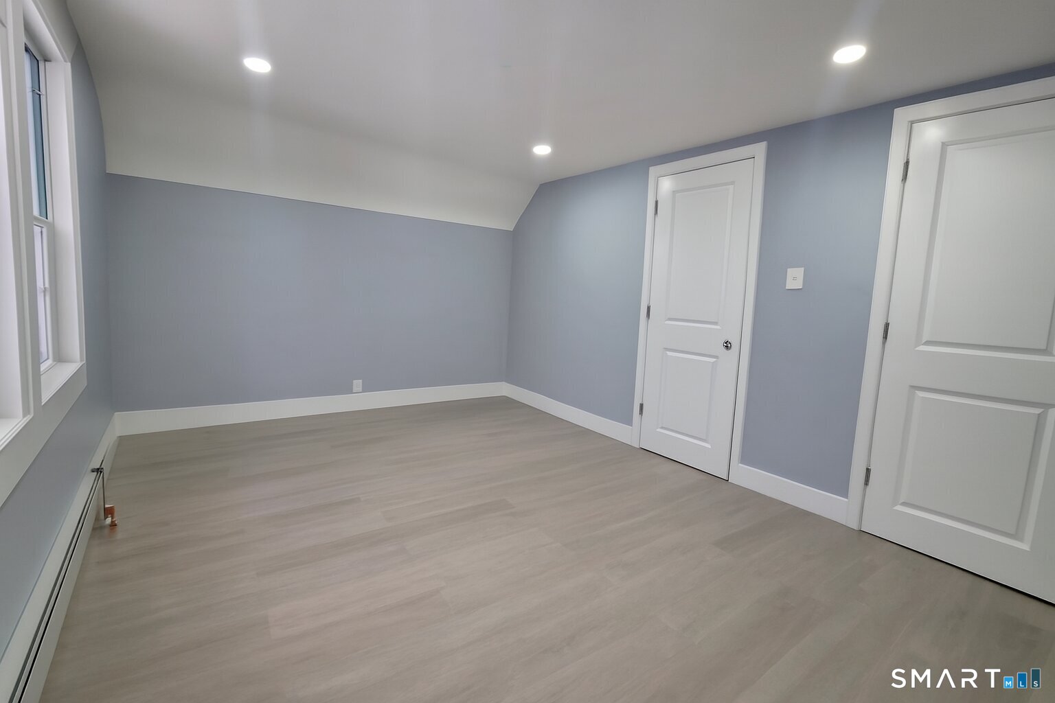 212 Platt Street Waterbury, CT 06704 - Photo 11 of 27 an empty room with wooden floor and window