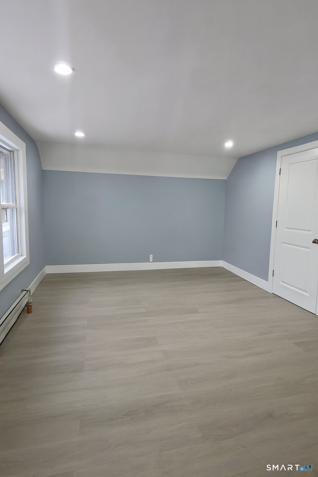 212 Platt Street Waterbury, CT 06704 - Photo 12 of 27 wooden floor in an empty room with a window