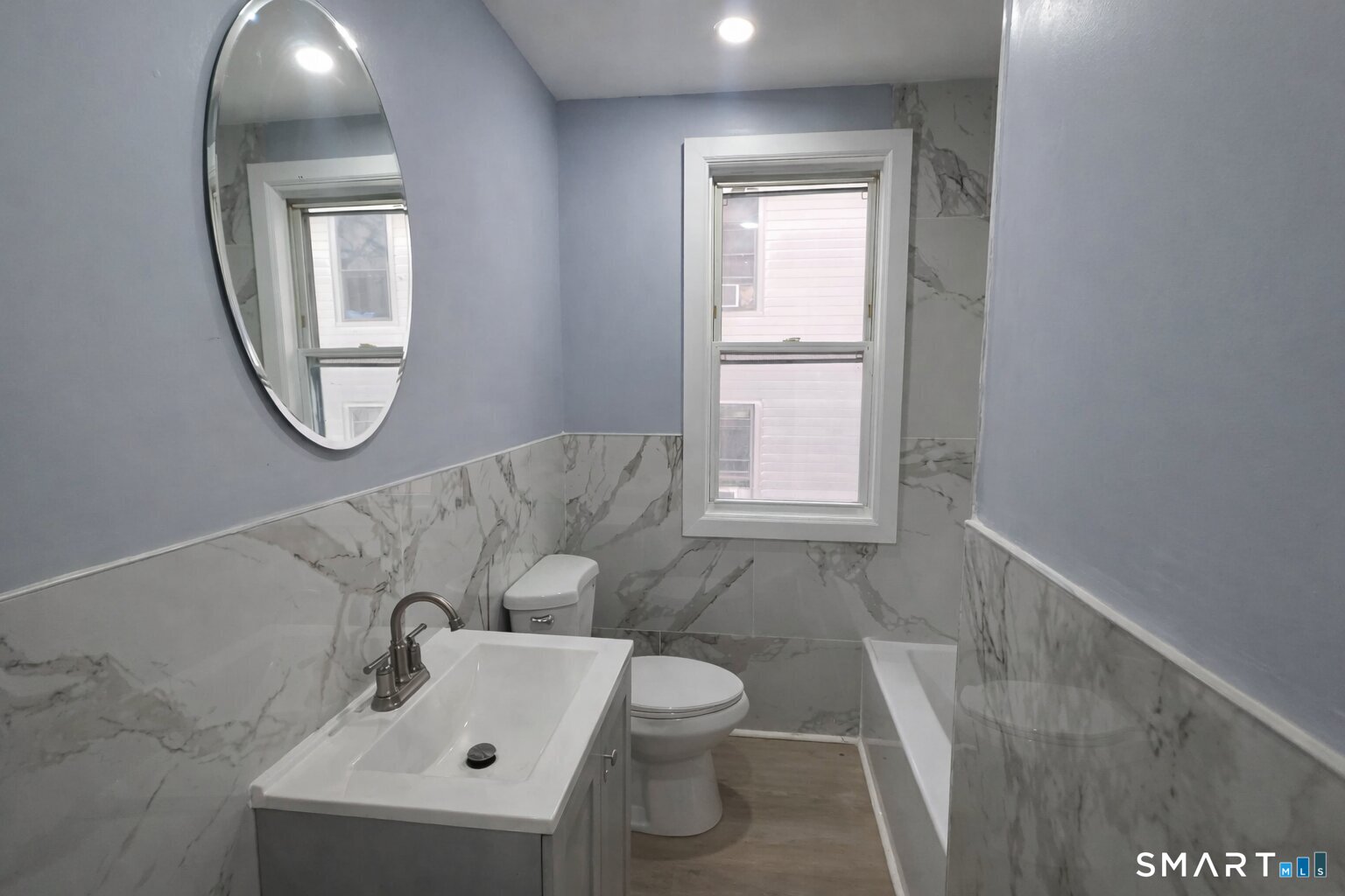 212 Platt Street Waterbury, CT 06704 - Photo 17 of 23 a bathroom with a toilet sink and mirror