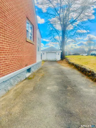 a view of a house with a yard and garage