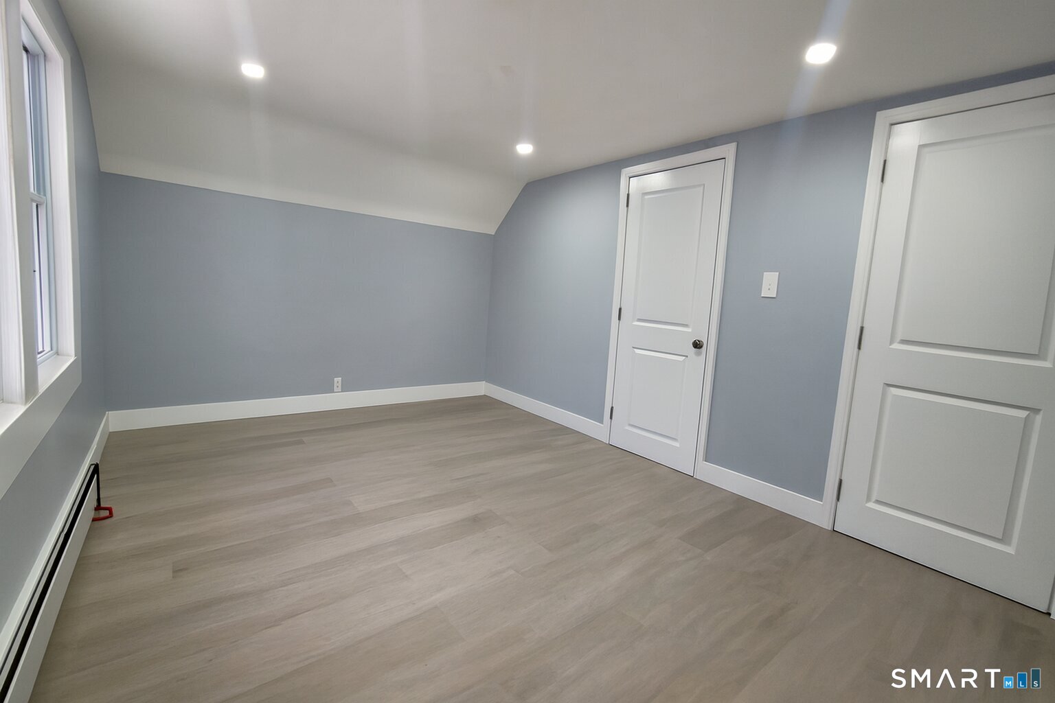 212 Platt Street Waterbury, CT 06704 - Photo 8 of 23 an empty room with wooden floor and window
