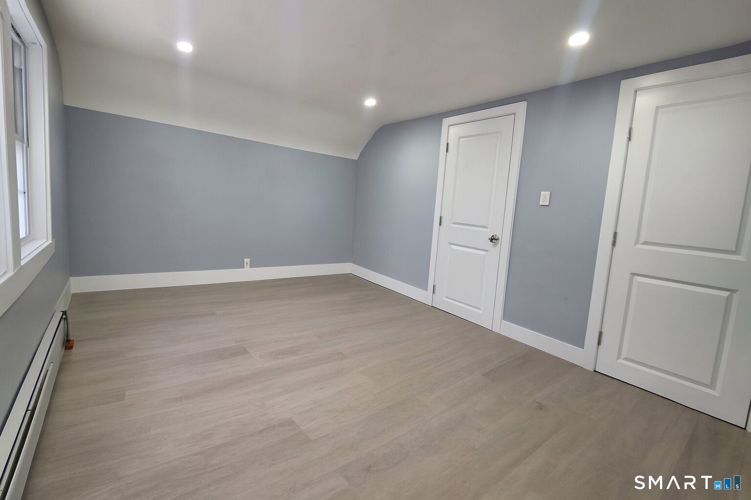 212 Platt Street Waterbury, CT 06704 - Photo 8 of 27 an empty room with wooden floor and window