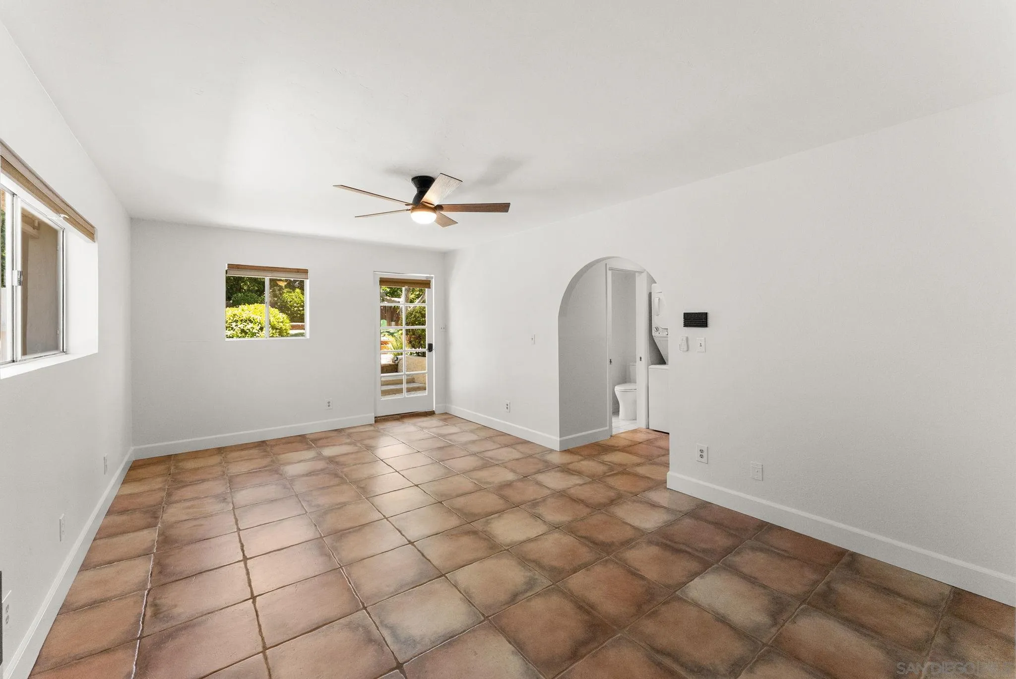 12832 Stone Canyon Road Poway, CA 92064 - Photo 42 of 60 a view of a livingroom with a chandelier fan and windows