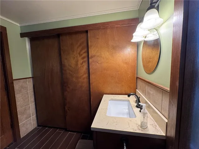 a living room with a fireplace and a walk in closet