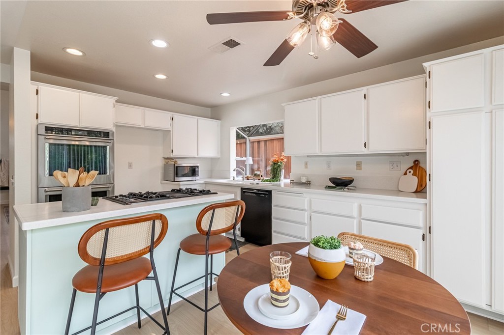 7529 Hardy Avenue Rancho Cucamonga, CA 91730 - Photo 13 of 38 a kitchen with a dining table and chairs