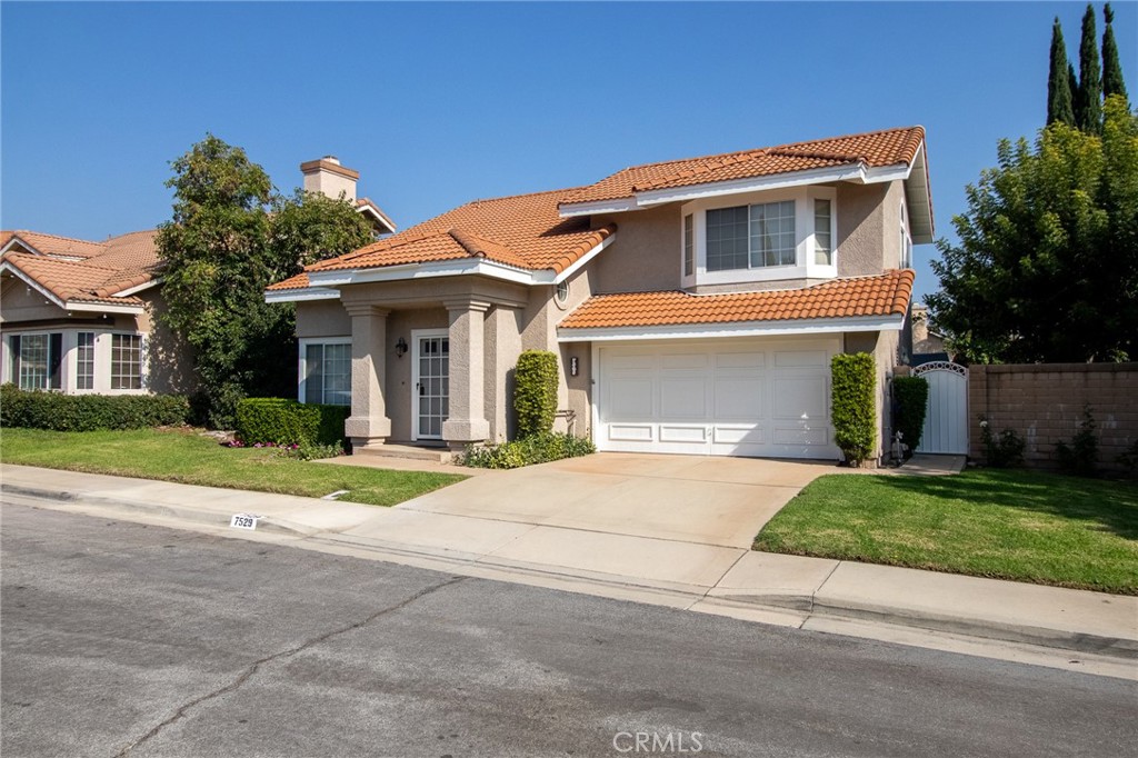 7529 Hardy Avenue Rancho Cucamonga, CA 91730 - Photo 2 of 38 a front view of a house with a yard and a garage
