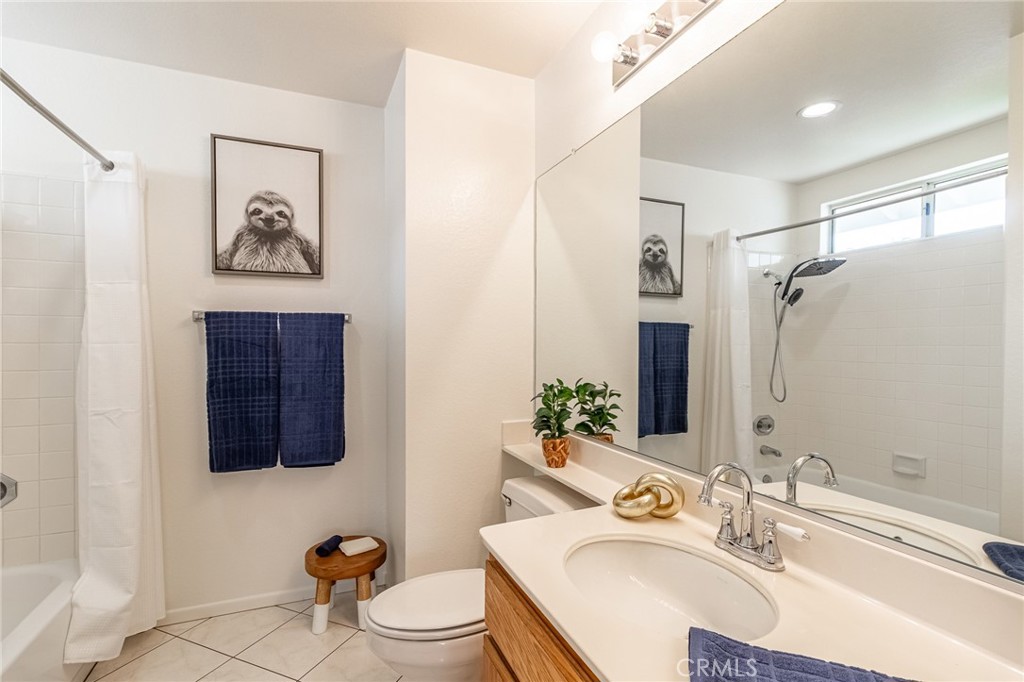 7529 Hardy Avenue Rancho Cucamonga, CA 91730 - Photo 23 of 38 a bathroom with a sink a mirror a vanity and a toilet