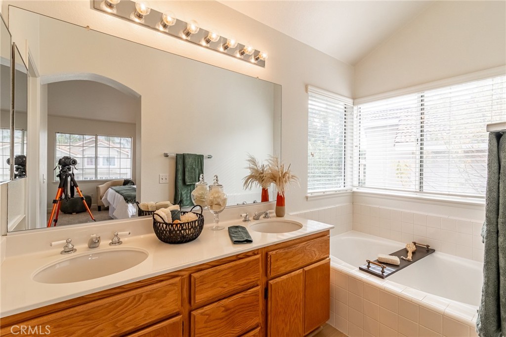 7529 Hardy Avenue Rancho Cucamonga, CA 91730 - Photo 30 of 38 a bathroom with a tub sink and mirror