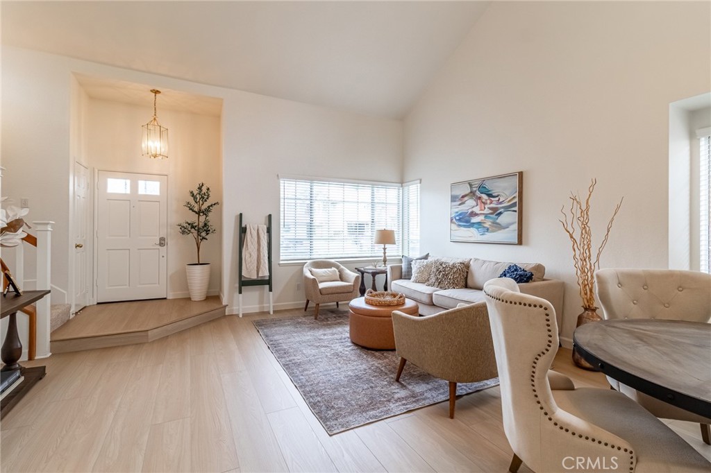 7529 Hardy Avenue Rancho Cucamonga, CA 91730 - Photo 7 of 38 a living room with furniture a large window and a rug