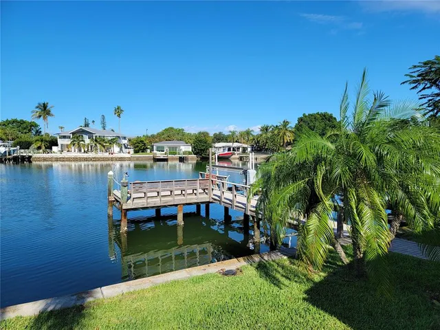 a view of a lake in middle of a field