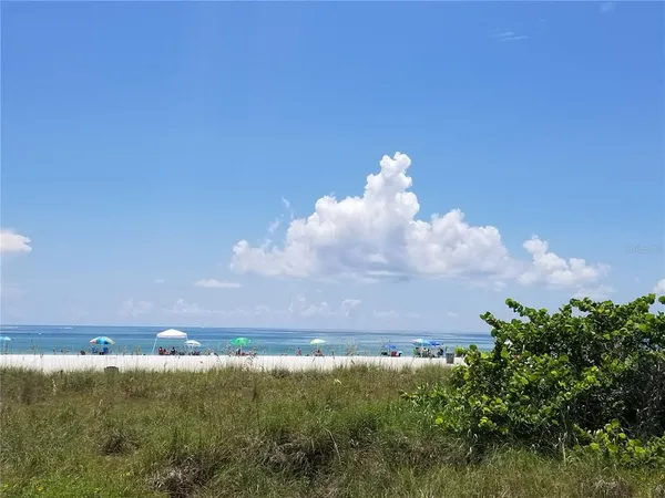 an aerial view of a city with lots of residential buildings ocean and boats