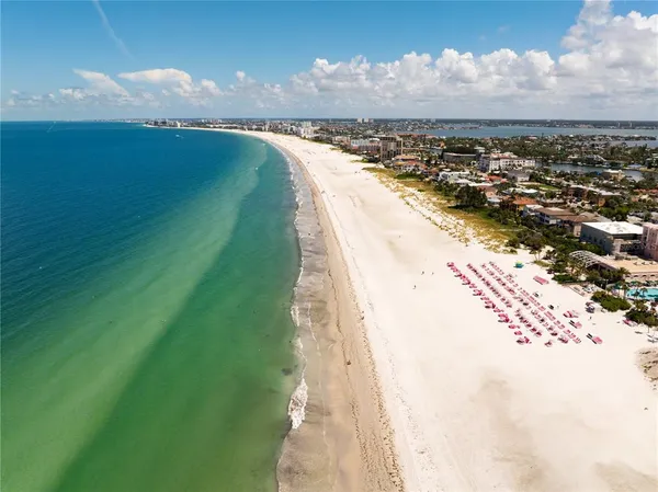 a view of a swimming pool with lawn chairs