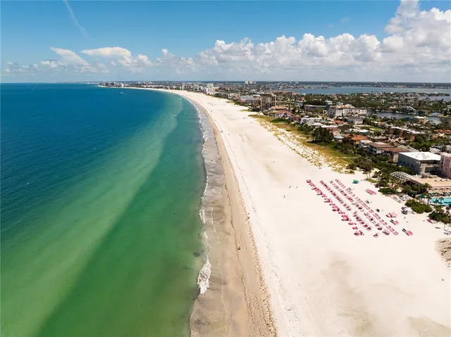 a view of a swimming pool with lawn chairs