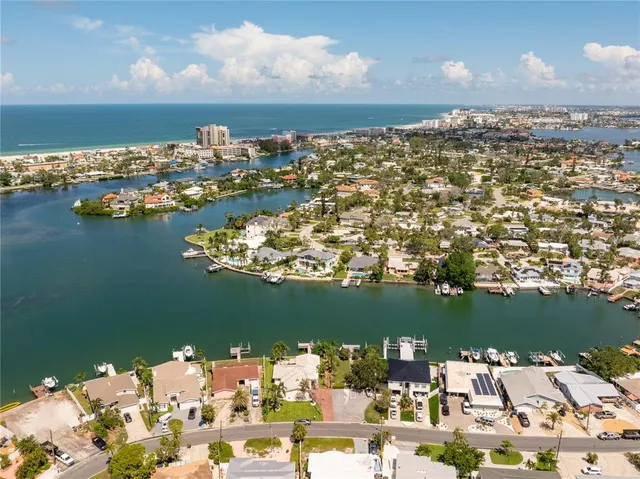 a roof deck with table and chairs potted plants with wooden floor
