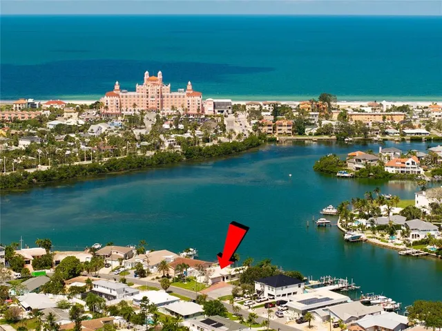 a view of a chairs and table in patio with a lake view