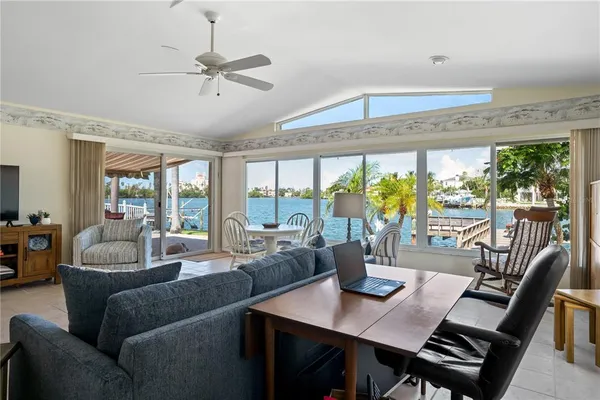 a kitchen with stainless steel appliances a table chairs refrigerator and microwave