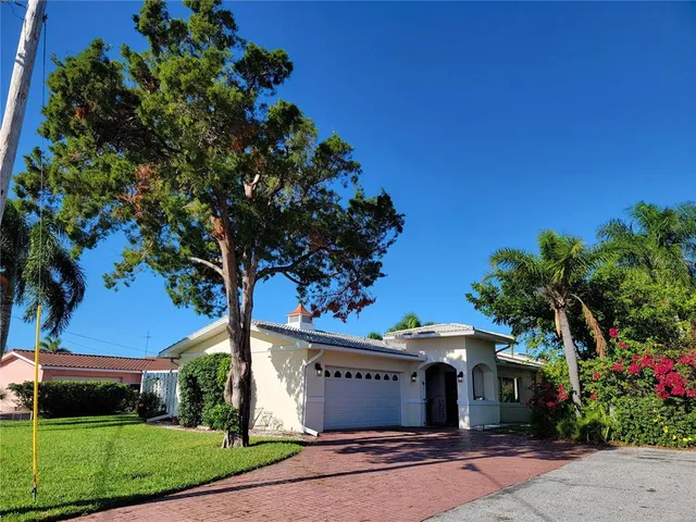 a view of a room with a dining table and chairs