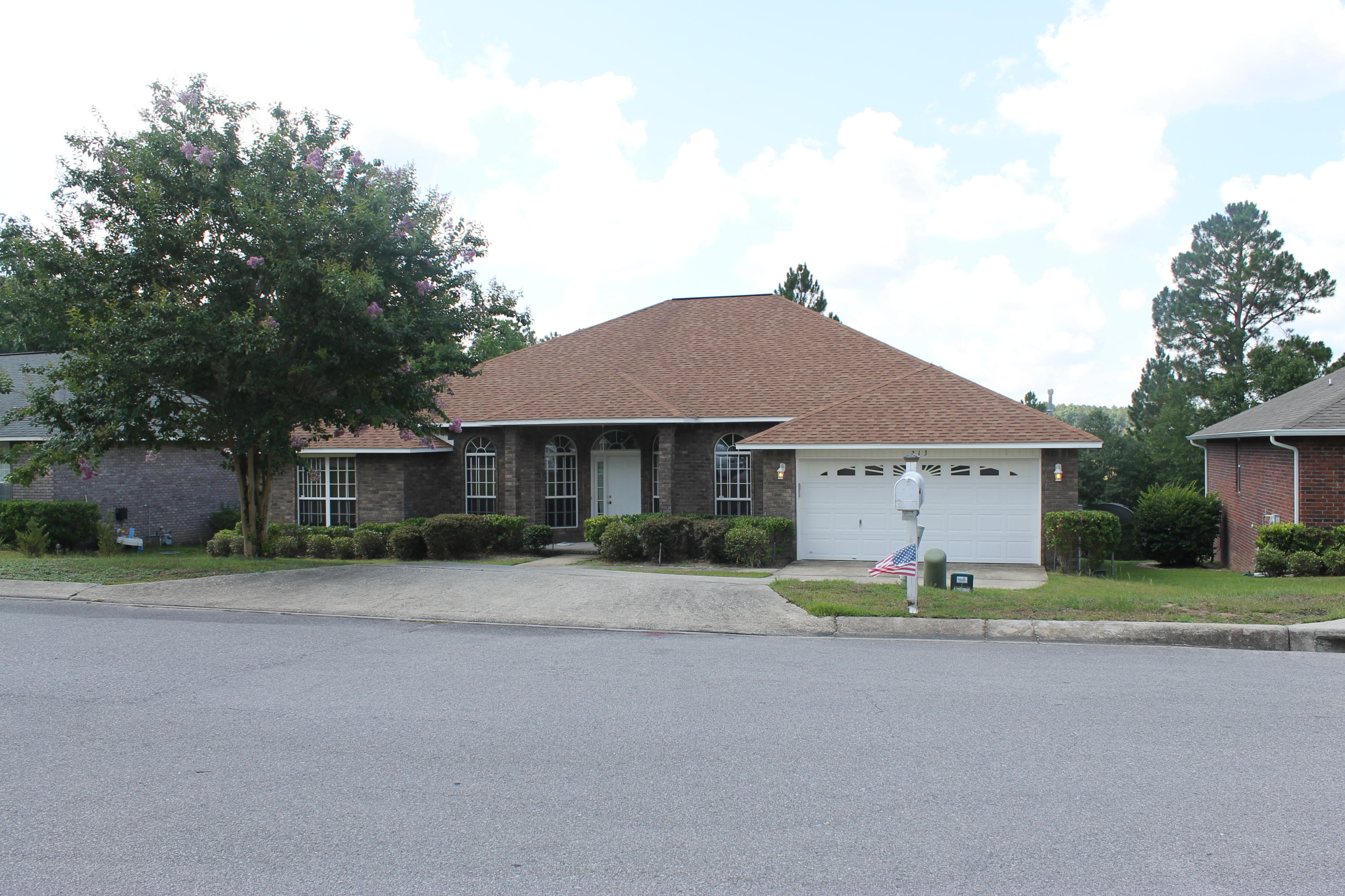 213 Foxchase Way Crestview, FL 32536 - Photo 2 of 34 a front view of a house with a garden and pathway