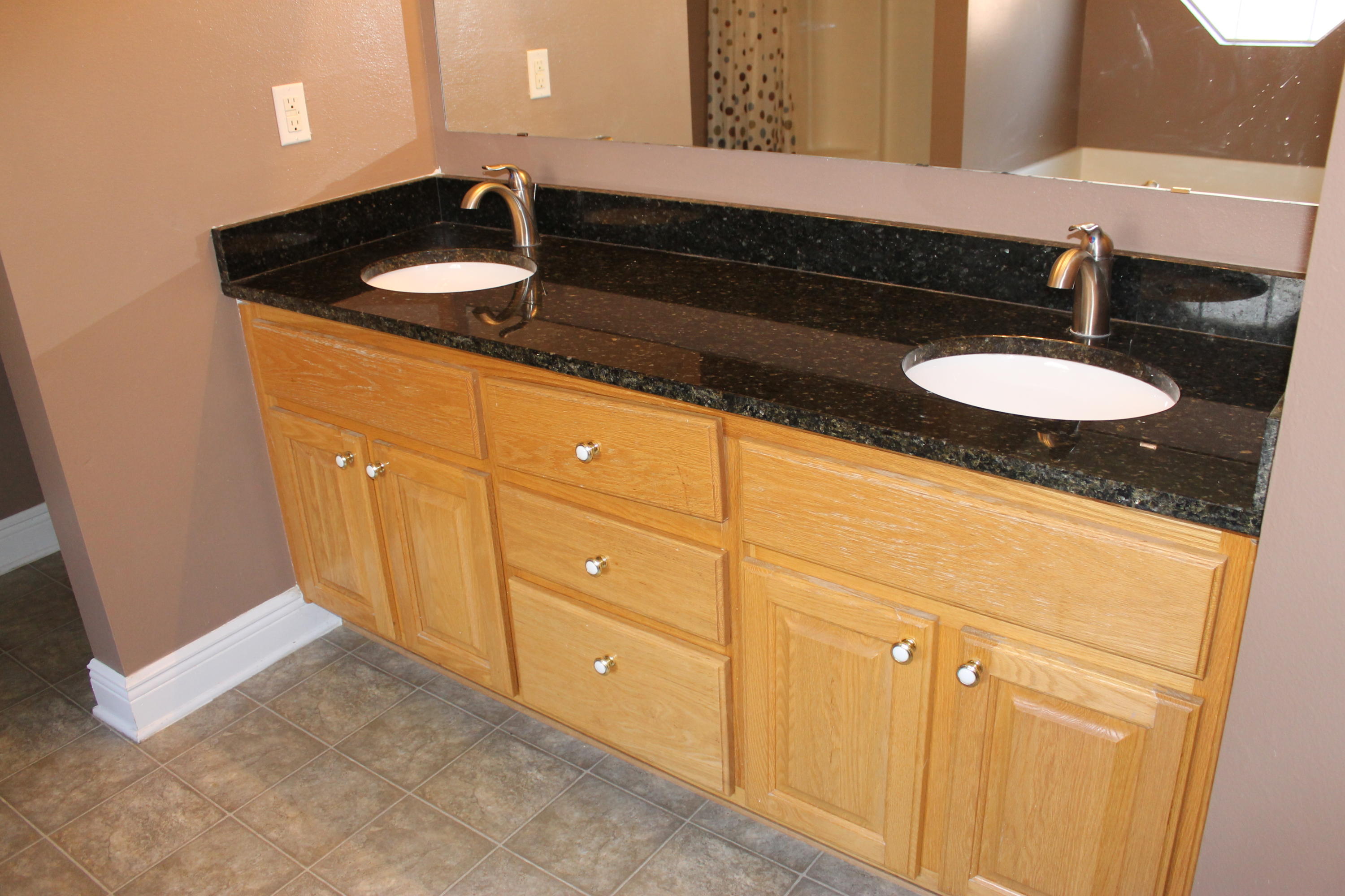 213 Foxchase Way Crestview, FL 32536 - Photo 22 of 34 a bathroom with a sink and a mirror