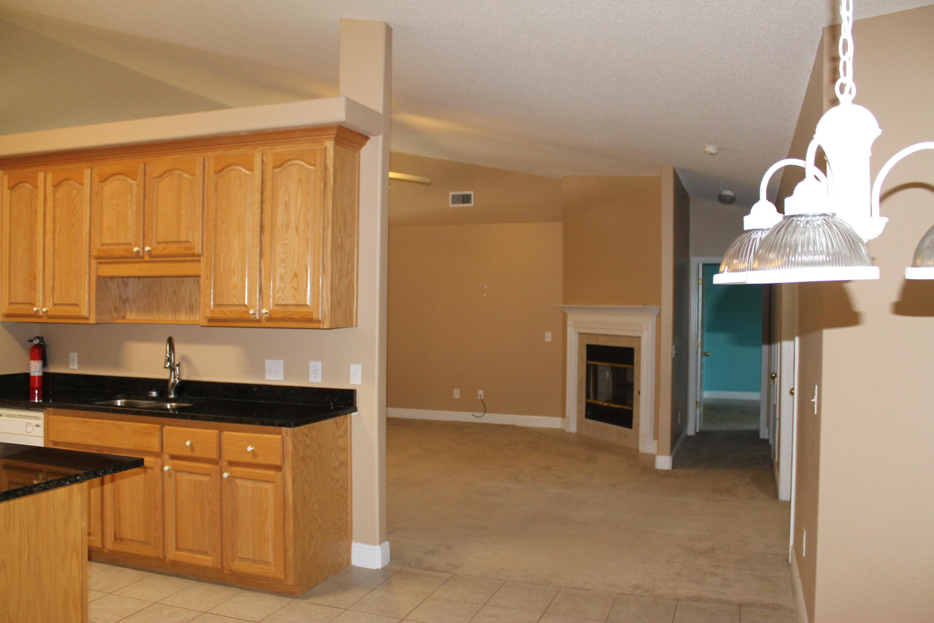 213 Foxchase Way Crestview, FL 32536 - Photo 10 of 34 a kitchen with granite countertop a sink and a stove top oven