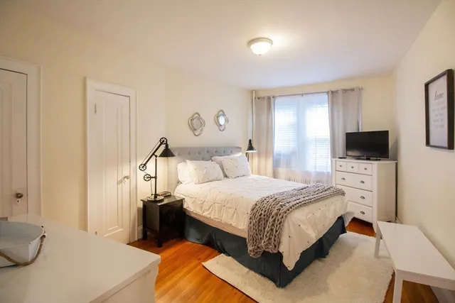 a bed room with a bed and a television