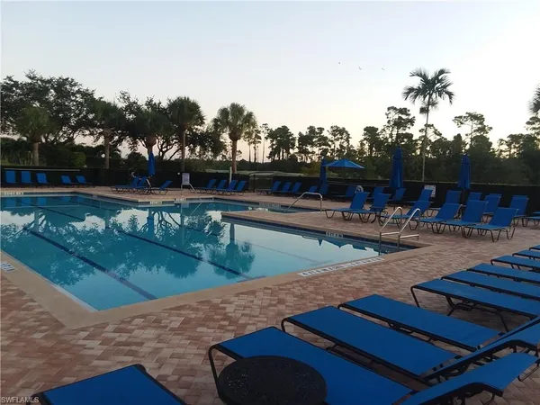a view of a swimming pool with outdoor seating