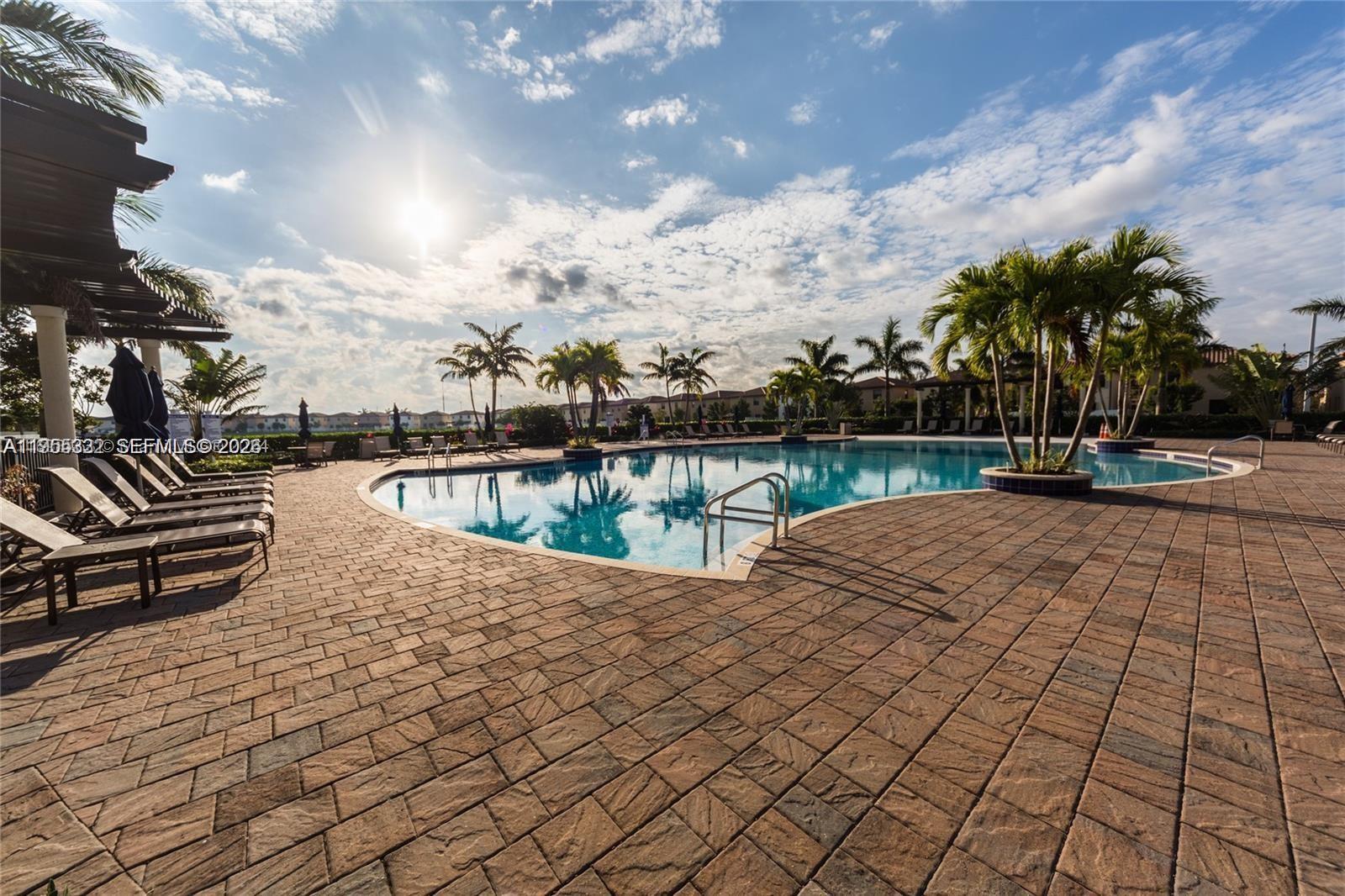 3353 West 91st Terrace Hialeah, FL 33018 - Photo 20 of 21 a view of a swimming pool with a lounge chairs