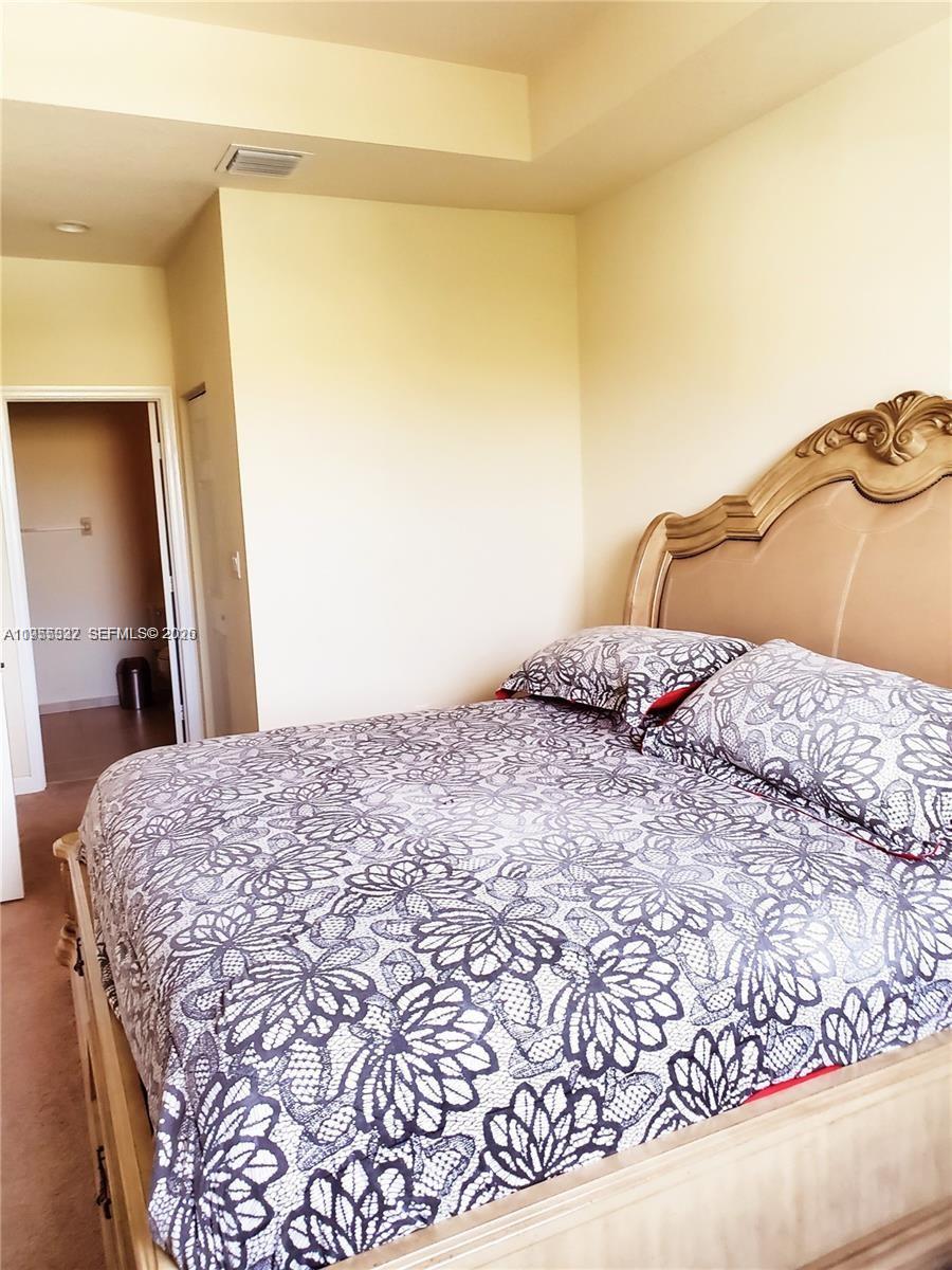 3353 West 91st Terrace Hialeah, FL 33018 - Photo 4 of 21 a bedroom with a bed and a mirror