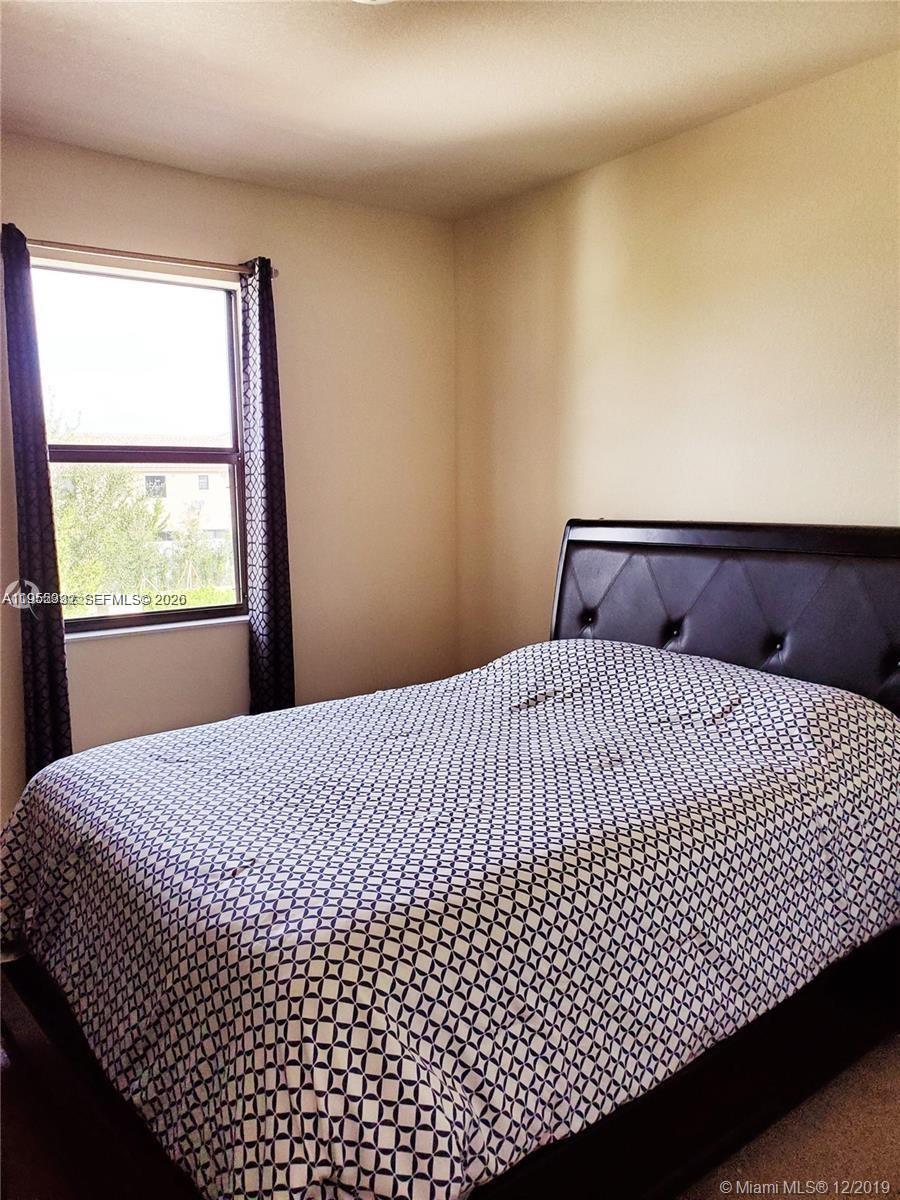 3353 West 91st Terrace Hialeah, FL 33018 - Photo 6 of 21 a bedroom with a bed and window