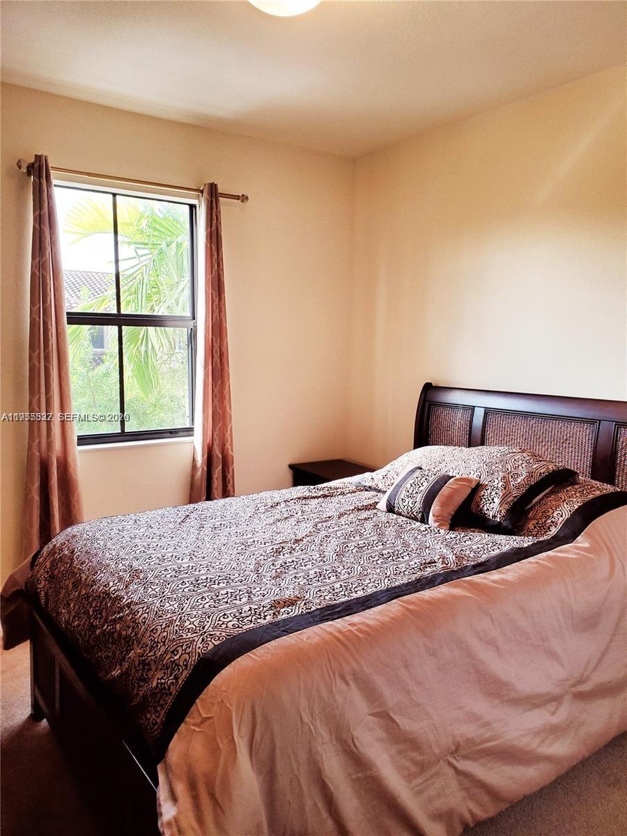 3353 West 91st Terrace Hialeah, FL 33018 - Photo 7 of 21 a bedroom with a bed and window